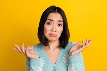 Photo of gloomy grumpy stressed depressed lady wear stylish clothes showing arms demonstrate no answer isolated on yellow color background