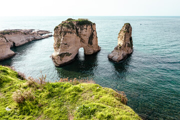 Fototapeta premium Raouche Rocks in Beirut, Lebanon in the sea during daytime. Pigeon Rocks in Mediterranean Sea. Popular Tourist Destination in Beirut. 