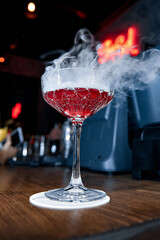 red cocktail with smoke