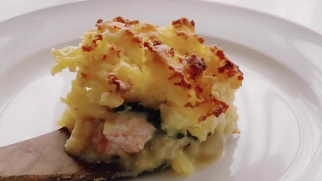 Comfort food and traditional English cuisine, portion of fish pie served on white plate, homemade recipe idea