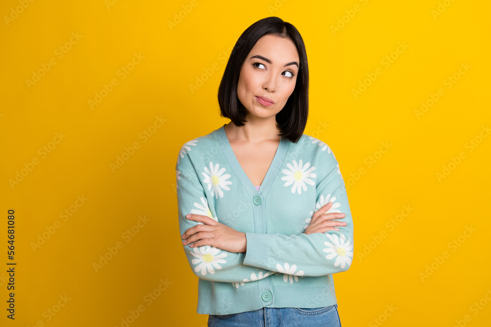 Sticker Portrait photo cadre of suspicious chinese girl folded arms looking empty space wear daisy flowers print pullover isolated on yellow color background