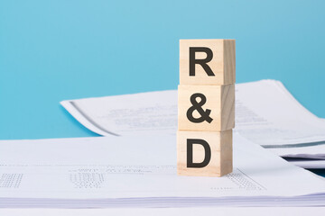 R and D - financial concept. wooden cubes on blue background