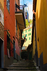 Fototapeta na wymiar A narrow pedestrian street with steps in Vernazza. The Cinque Terre. Italy. Famous touristic place and travel destination. UNESCO World Heritage Site