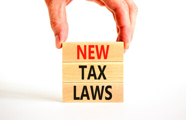 New tax laws symbol. Concept words New tax laws on wooden blocks on a beautiful white table white background. Businessman hand. Business new tax laws concept. Copy space.