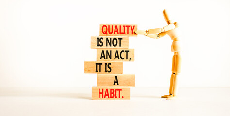 Quality is a habit symbol. Concept words Quality is not an act it is a habit on wooden blocks. Beautiful white table white background. Businessman icon. Business quality is habit concept. Copy space.