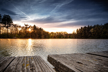 stage on a lake at sunset, cloudy day
