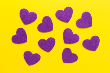 Felt hearts on color background, top view