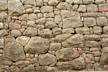 Stone wall for background design. A backing with natural stones for branding, calendar, screensaver, wallpaper, poster, banner, cover, website. A place for your design or text. High quality photo