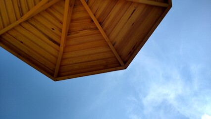 Beach umbrella on the beach made of wood