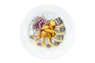 Pieces of herring in potatoes and onions in a plate. Appetizing traditional snack. Top view. Close-up. Isolated on white background.