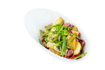 Hunting salad of smoked sausages, potatoes and green onions. Appetizing traditional snack for beer. Close-up. Isolated on white background.
