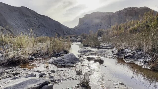 Stream of water on the bottom of canyon at Tabernas Desert, Andalusia, Spain,