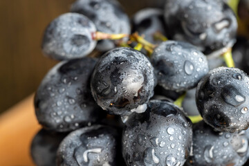 Wet black and blue grapes on the table