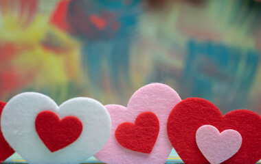 Hearts of different colors on a colored background with a place to copy. valentine's day. Lovers.