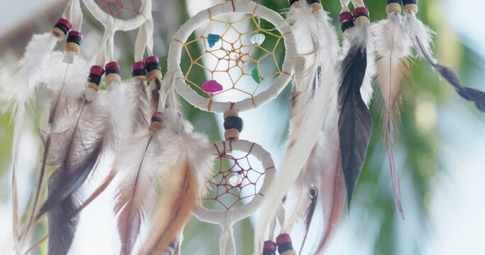 Ethnic attribute talisman hanging on the street. Sunny bright day. Decorative talisman amulet floats in the air. Dreamcatcher talisman ethnic attributes concept