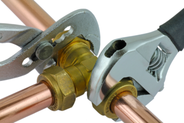 Plumbing wrenches adjusting fitting on pipework. transparent png.