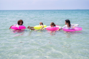 Teenage girl friendship enjoy laughing play on sea swimming with water inflation toy on blue sky day