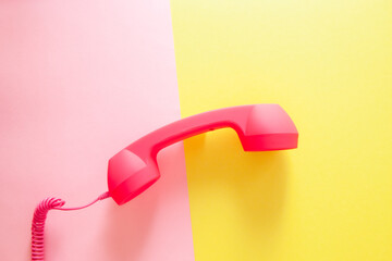 Phone or handset on yellow and pink background, colorful card with communication and connection...