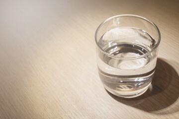 Selective focus on the glass cup which contained pure natural water as most simple health benefits...