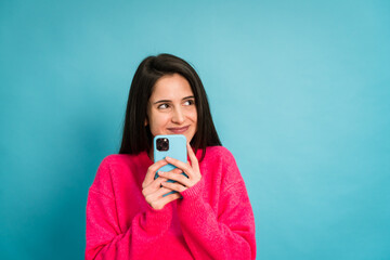 Fototapeta premium Young woman with smartphone in studio