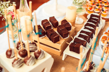 Chocolate brownie cake, with wood background and sweet table
