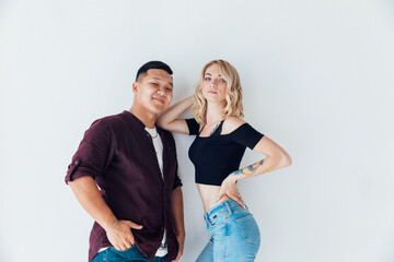 a couple of lovers pose together standing on a white background