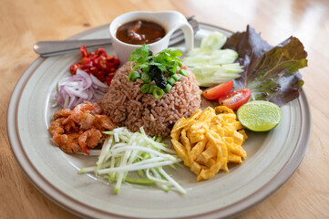 Fried rice mixed with shrimp paste with marinated pork, herb and vegetable is Thai traditional food