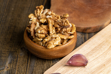 Peeled walnuts in a wooden bowl on the table