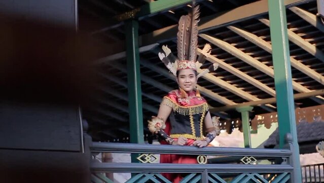 Young women Dayak standing at the village park