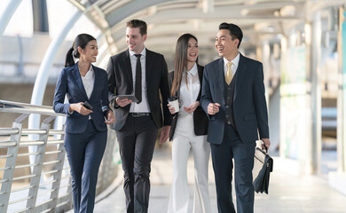 Business people walking and talk to each other in front of modern office