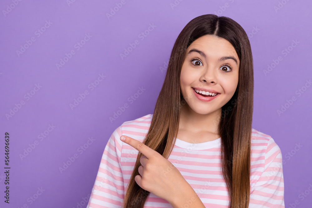 Sticker photo of positive astonished girl indicate finger empty space isolated on violet color background