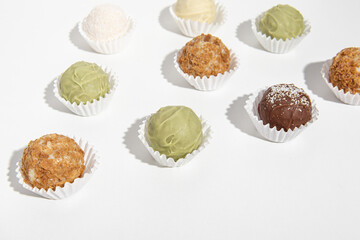 Tasty sweet truffles on white background. Professional pastry chef or chocolatier