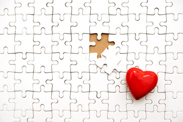 Valentine hearts on a white blank jigsaw puzzle, with one piece missing
