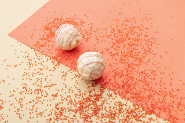 Natural healthy candies with white chocolate on red background. Red confectionery sugar