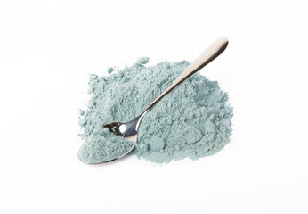 Blue spirulina powder in spoon isolated on white background. Natural vegan superfood. food supplement.