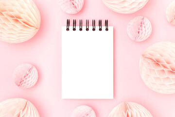 Blank notepad mockup and tissue paper balls on a pink background. Monochrome concept.