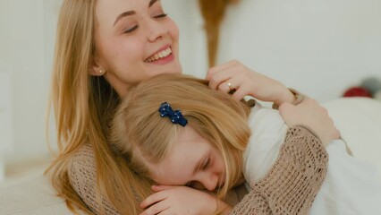 Happy Caucasian loving mother hug cuddle embrace comfort little cute daughter stroke head of affectionate adopted kid girl child hugging adorable baby care parent mom embracing cuddling family tender