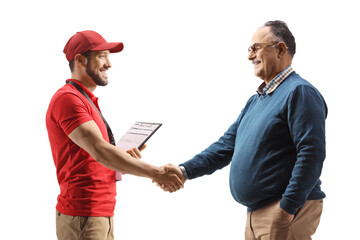 Profile shot of a delivery man shaking hands with a mature man