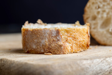 Sliced wheat baguette on a board