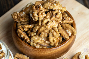 Peeled walnuts on a wooden surface