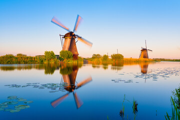 Kinderdijk National Park in the Netherlands. Windmills at dusk. A natural landscape in a historic location. Reflections on the water surface. Dutch canals. UNESCO World Heritage Site. © biletskiyevgeniy