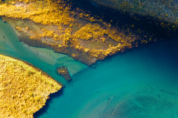A drone view of the river . An aerial view of an autumn field. Pond among the meadows. Turquoise...