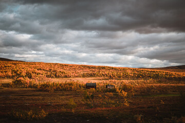 Beautiful norwegian landscape with a typical norwegian house, mountains in the background and moody rainy weather