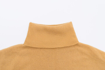High collar ocher wool sweater on white isolated background, top view. Mockup for your design