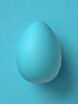 Easter egg on blue background. Monotone image with egg shell texture. 3D Render