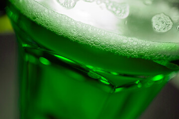 A glass of green beer is a symbol of St. Patrick's Day, close-up, macro