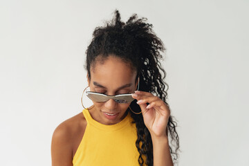 attractive black african american woman posing in stylish hipster outfit on white background