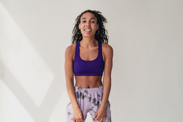 attractive black african american woman in stylish hipster fitness outfit on isolated background