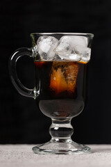 Preparation of cold coffee. Coffee and milk are poured into a glass with ice