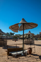 Beautiful abandoned beach. Umbrellas and sunbeds on the beach. Sunny summer day. Beautiful abandoned beach.
